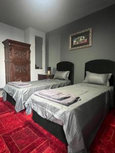 a bedroom with two beds and a dresser at Apartament Panorama in Pomorie