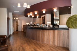 a lobby of a restaurant with a bar at Domaine Golf Saint-Lazare in Limoges