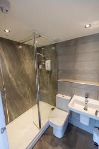 a bathroom with a shower and a toilet and a sink at Short Croft Cottage - Idyllic, dog-friendly country retreat in Holbeck