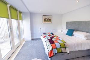 a bedroom with a bed and a large window at Short Croft Cottage - Idyllic, dog-friendly country retreat in Holbeck