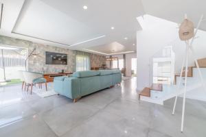 ein Wohnzimmer mit einem blauen Sofa und einem Tisch in der Unterkunft Villa Alva in Aroeira