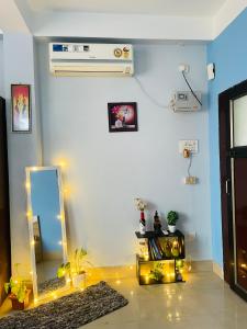a room with a mirror and a dresser with lights at Urban loft cozy 1bhk Homestay in Guwahati