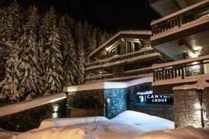 a snow covered building with a christmas tree at Canyon Lodge by Alpine Resorts in Saint-Bon-Tarentaise