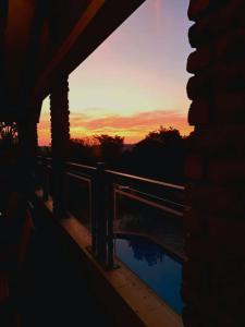 a view of a sunset from a balcony of a building at Cycad Place Midrand Guesthouse and B&B in Midrand +29 photos