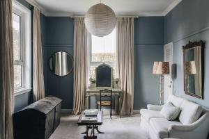 a blue living room with a couch and a table at Seymour House in Moss Vale +94 photos