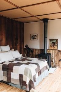 a bedroom with a bed and a wood stove at Seymour House in Moss Vale