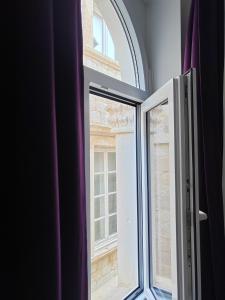 an open window with a view of a building at Mare et Silva Apartment Dubrovnik in Dubrovnik