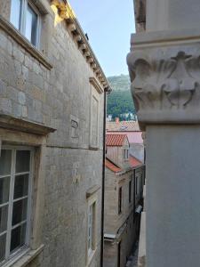 a view of an alley between two buildings at Mare et Silva Apartment Dubrovnik in Dubrovnik