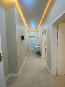 a hallway with a bathroom with a toilet and a ceiling at أفضل ليلة وحدات سكنية بطابع منزلي in Al Hofuf +15 photos