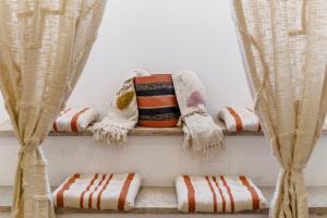 a shelf with blankets and pillows and curtains at All2gether Apartment in Lisbon +38 photos