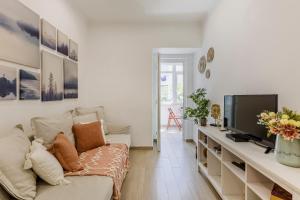 a living room with a couch and a television at All2gether Apartment in Lisbon