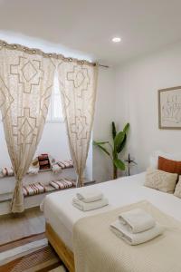 a bedroom with two beds and a window at All2gether Apartment in Lisbon
