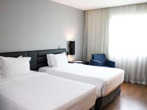 Postel nebo postele na pokoji v ubytování Grand Mercure Sao Paulo Vila Olimpia