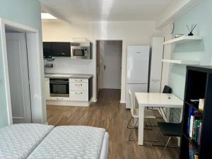a small kitchen with a bed and a table at Všemina apartmán 31 in Všemina