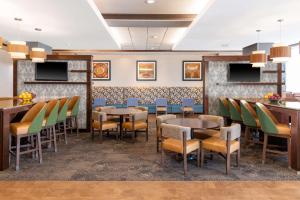 a dining room with tables and chairs and televisions at Hampton Inn & Suites Madison Downtown in Madison