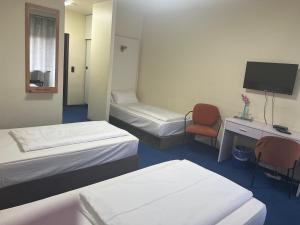 Postel nebo postele na pokoji v ubytování Hotel Am Flughafen