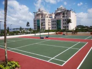 a tennis court in front of a large building at Vista Alam P Small Studio in Shah Alam