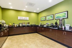 a coffee shop with green walls and wooden cabinets at Sleep Inn & Suites in Pleasanton