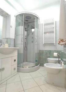 a bathroom with a shower and a toilet and a sink at Luminose Camere a San Martino in Genova