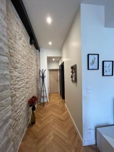 a hallway of a house with a stone wall at Loft Pasteur - Homillesime in Dijon