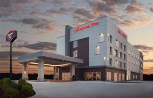 a building with a sign on the side of it at Hampton Inn Ogallala in Ogallala