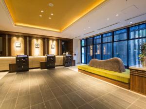 a hotel room with a bed and a large window at Hotel Keihan Yodoyabashi in Osaka +29 photos