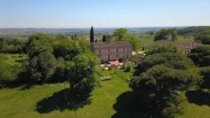 an aerial view of a house on a green field at Lodge Robinson aux Nuits Insolites d'Argoumbat in Beaumont-de-Lomagne