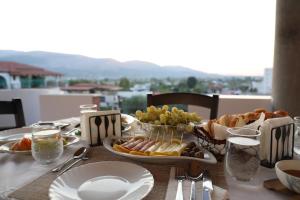 a table with a plate of food on a table at Georgemishel Guest House in Berat