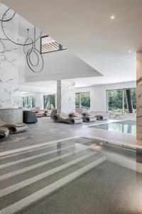 a living room with a swimming pool with couches at Cervino - VRetreats in Breuil-Cervinia