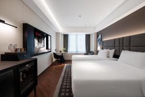 Postel nebo postele na pokoji v ubytování IntercityHotel Xi'an Dayan Pagoda by DH