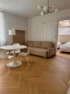 een woonkamer met een bank, een tafel en stoelen bij Apartamenty przy Winnicy in Busko-Zdrój