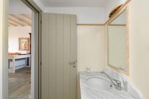 a bathroom with a bath tub and a mirror at Villa Ourania in Kampos Paros +16 photos