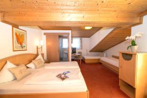 a hotel room with two beds and a staircase at Hotel Glasererhaus in Zell am See