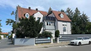 a white car parked in front of a house at Apartment am Ronhof in Fürth
