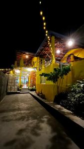 a house lit up at night with lights on it at Casa da Vila - Hospedaria - 3 min do centrinho de Alter in Alter do Chao