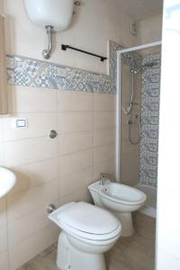 a bathroom with a toilet and a sink and a shower at Locanda de foris apartment in Teano
