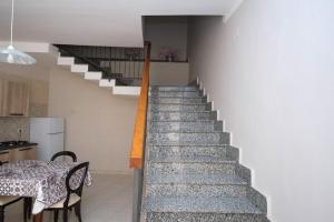 a staircase in a house with a table and a dining room at Locanda de foris apartment in Teano
