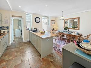 a kitchen and living room with a counter and a table at Pip's Corner in Lynton