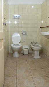 a bathroom with a toilet and a bidet and a sink at Sevilla Home Hotel in Buenos Aires +79 photos