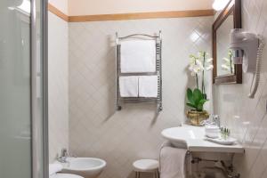 Un baño blanco con lavabo e inodoro. en Valle di Assisi Villa Privata, en Tordandrea