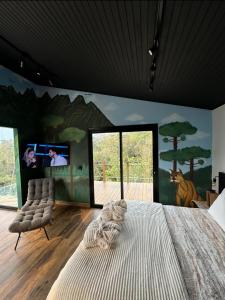 a bedroom with a large bed and a flat screen tv at Refúgio Paraíso Casa Splendore Spa Panorâmico in Orleans