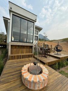 a home with a fire pit on a wooden deck at Refúgio Paraíso Casa Splendore Spa Panorâmico in Orleans