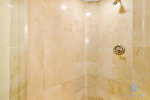 a shower stall with a glass shower door at Deluxe Studio Ocean View Premium Amenities in Sunny Isles Beach