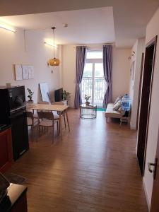a living room with a table and a dining room at Cozy Apartment 2BR Hacom Phan Rang in Kinh Dinh +15 photos