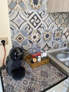 a bathroom with a counter with a sink and tiles at Il palazzo Dei Normanni in Motta SantʼAnastasia +22 photos