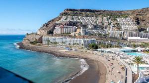 a view of a beach with hotels and the ocean at Sea View Cura Marina 415 in Playa del Cura