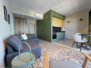 a living room with a couch and a table at Seafront Apartment Koroni in Koroni