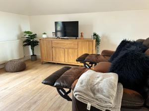 a living room with a couch and a flat screen tv at New! Central Penthouse, King Size Bed & Balconies in Maidstone