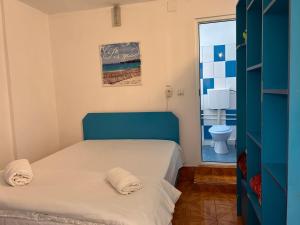 a small bedroom with a bed and a toilet at Camere de închiriat Doriana in Vama Veche
