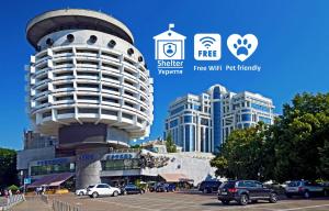 a building with cars parked in a parking lot at Salute Hotel in Kyiv